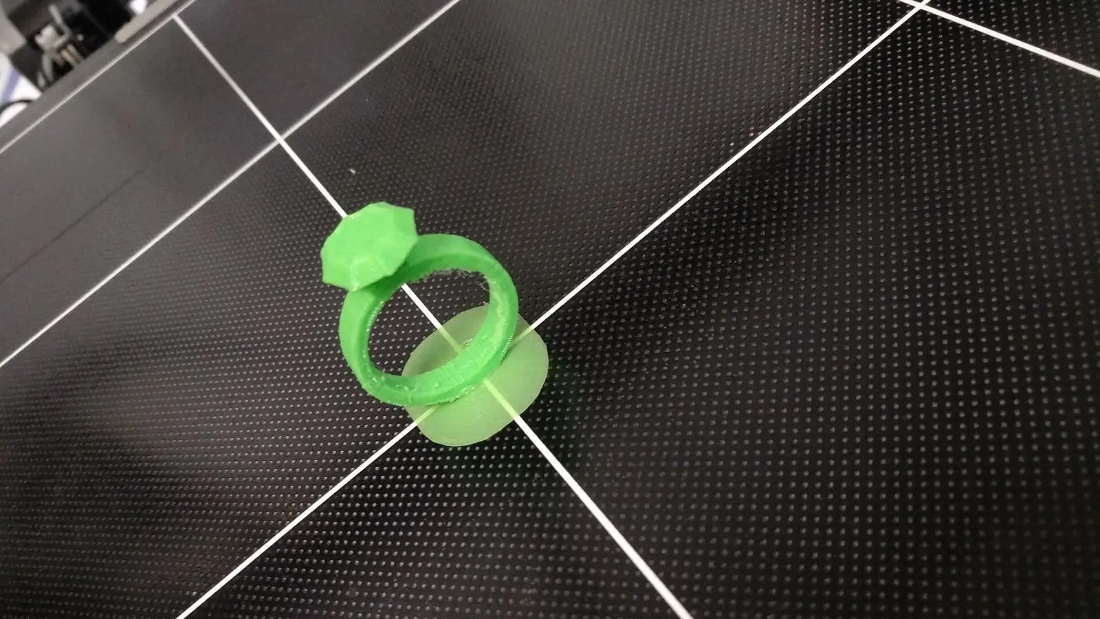 Small 3D-printed part on a perforated printer build plate
