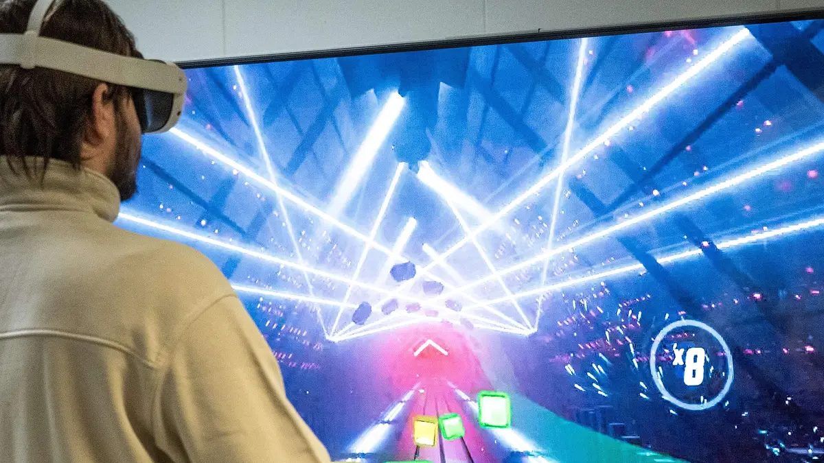 User wearing a VR headset in front of a virtual corridor display