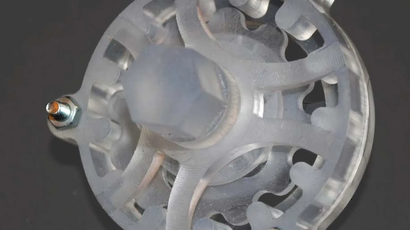 Translucent printed hub part resting on a dark surface